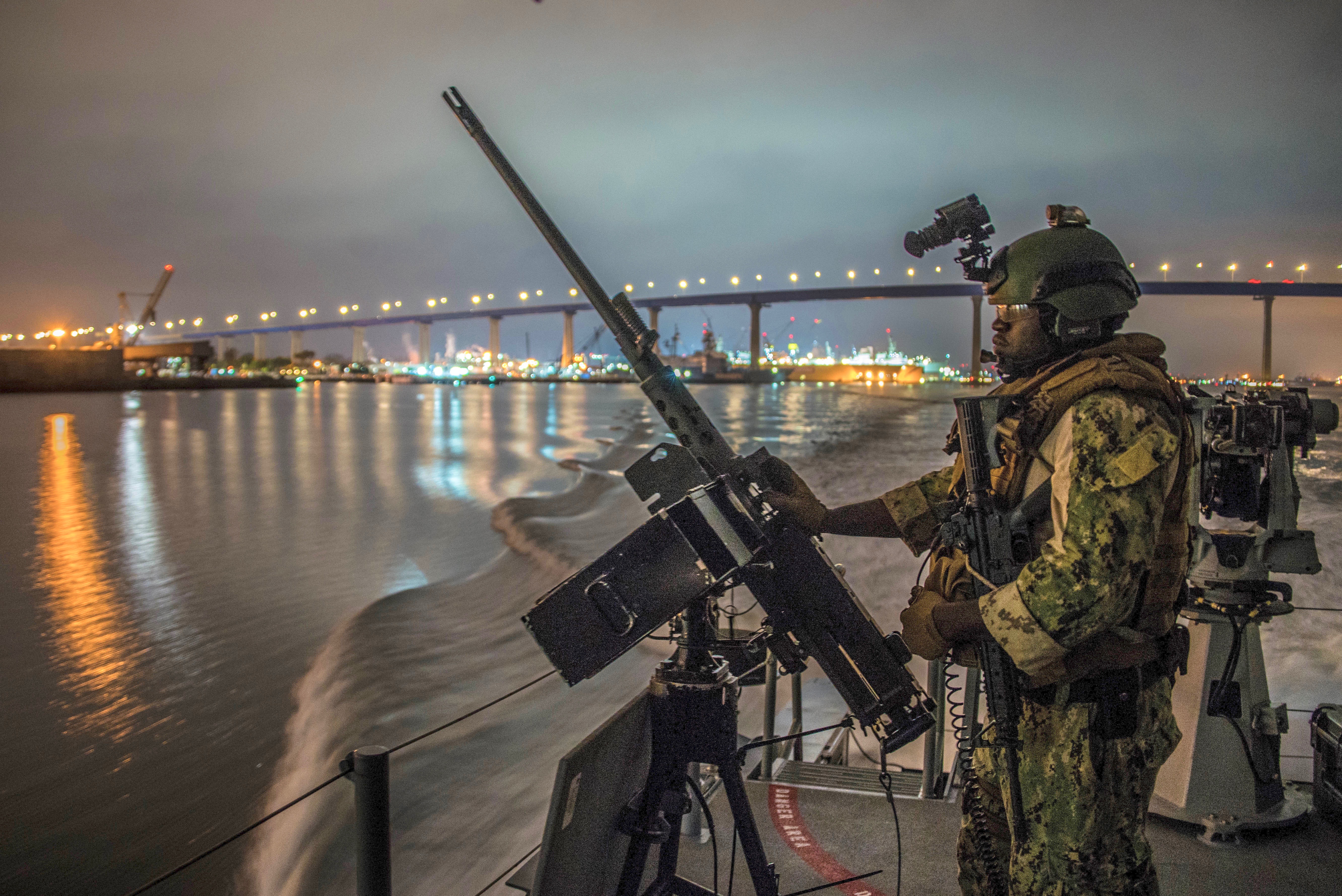 Quartermaster 1st Class Troy Wilson, from New York, assigned to Coastal Riverine Squadron 3, mans the M2A1 .50-caliber machine gun aboard a Mark VI patrol boat as it transits outbound in San Diego Bay during unit level training provided by Coastal Riverine Group 1 Training and Evaluation Unit on Oct. 17. (U.S. Navy photo by Chief Boatswain’s Mate Nelson Doromal Jr.)