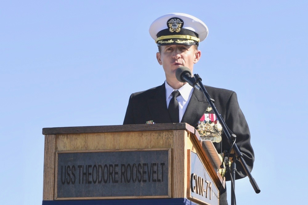 Capt. Brett Crozier addresses the crew for the first time as commanding officer of the aircraft carrier USS Theodore Roosevel during a change of command ceremony on the ship’s flight deck. Crozier relieved Capt. Carlos Sardiello to become the 16th commanding officer of Theodore Roosevelt. (U.S. Navy photo by Mass Communication Specialist 3rd Class Sean Lynch)
