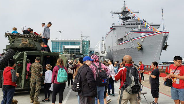 Visitors tour the USS Harpers Ferry and inspect Marine Corps combat equipment during Fleet Week 2018. (Courtesy of the San Diego Fleet Week Foundation)