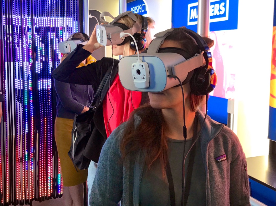 Visitors to the Cubic Corporation’s bus tour view an unconscious bias demonstration through the use of digital viewfinders. (Photo courtesy of Cubic Corporation)