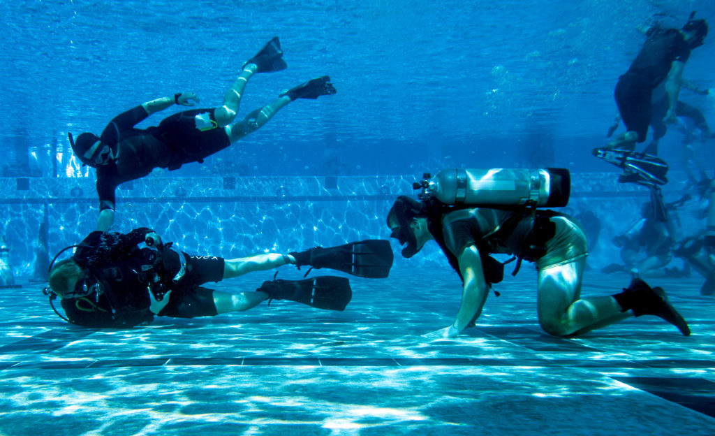 CORONADO -- Mass Communication Specialist 3rd Class Alex Perlman, left, assigned to Commander, Naval Special Warfare Command, photographs U.S. Navy SEAL candidates participating in Basic Underwater Demolition/SEAL training. NSWC is the maritime component of U.S. Special Operations Command, and its mission is to provide maritime special operations forces to conduct full-spectrum operations, unilaterally or with partners, to support national objectives. (U.S. Navy photo by Mass Communication Specialist 1st Class Sean Furey)