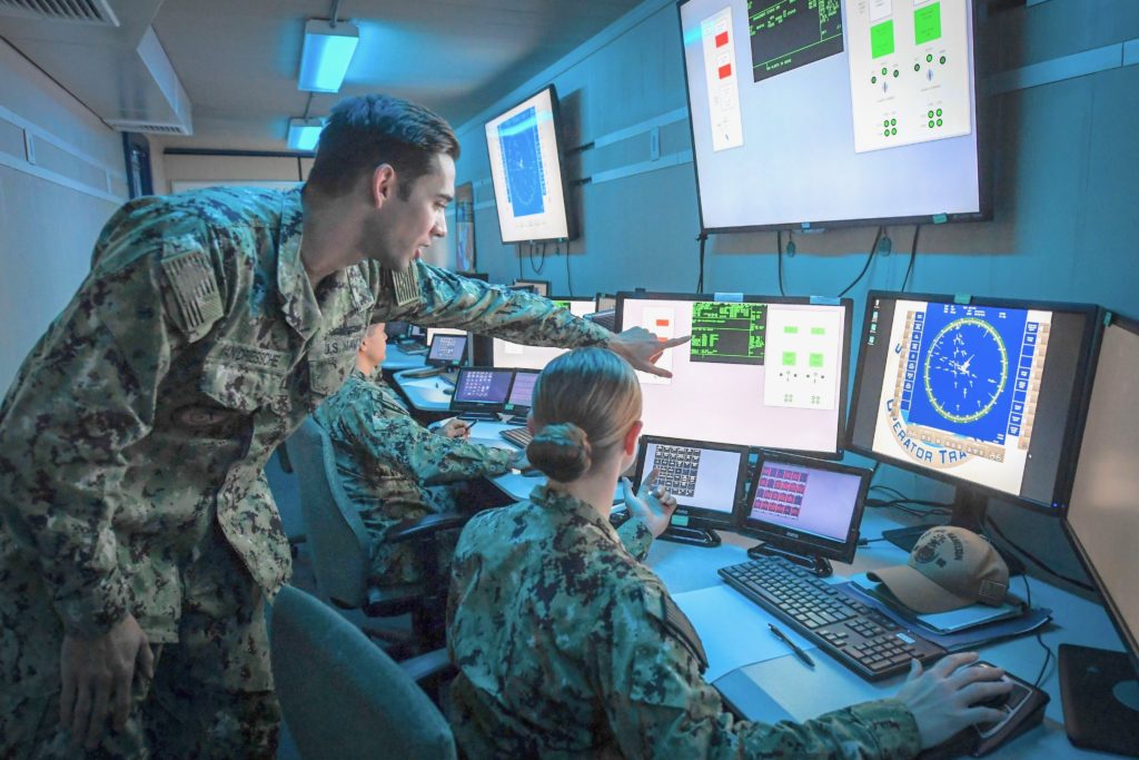 SAN DIEGO -- Lt. Aaron Van Driessche, a warfare tactics instructor at the Center for Surface Combat Systems, Detachment San Diego, pilots the U.S. Navy’s virtual combat curriculum with sailors assigned to the guided-missile destroyer USS Paul Hamilton inside the newly launched portable simulator, the On Demand Trainer. (U.S. Navy photo by Mass Communication Specialist 2nd Class Joseph Millar)