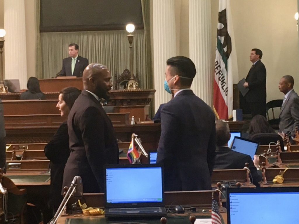 Assemblymember Evan Low wears a protective mask on the floor as lawmakers gather to address the coronavirus emergency. (Photo by Laurel Rosenhall for CalMatters)