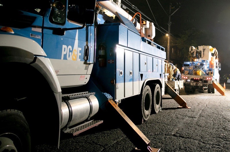 PG&E employees work to replace a nearly 100-year-old utility pole in Berkeley last year. (Photo by Anne Wernikoff for CalMatters)