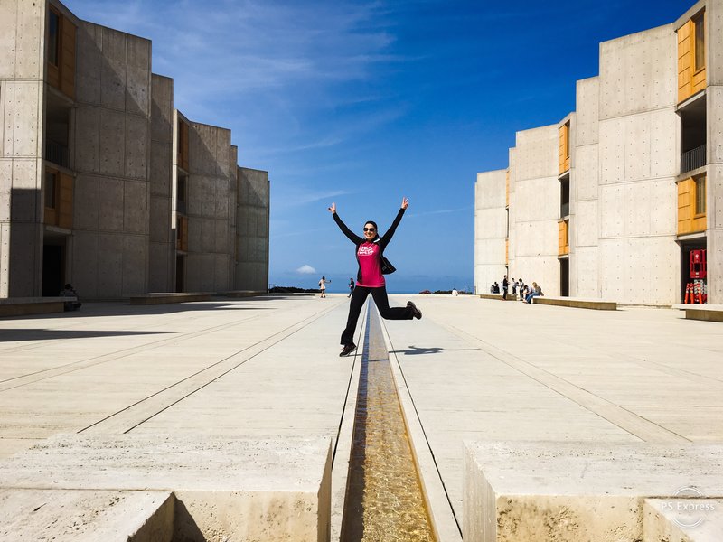 The monumentality of world-renowned architect Louis Kahn’s vision for the Salk Institute is particularly felt in the open courtyard of travertine marble, bisected by a ribbon of water (jumped over by Rosy Jaurena of Tijuana) that leads your eye to the ocean beyond. / Thomas Melville/Beach & Bay Press)
