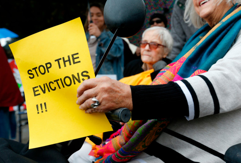 Resident Martha Kapla, right, holds a sign during a rally in front of an assisted-living home in San Pablo, Calif., in December. Nearly 80 elderly and disabled residents were told to be out of the building by the end of January. (Photo by Jane Tyska, Bay Area News Group)