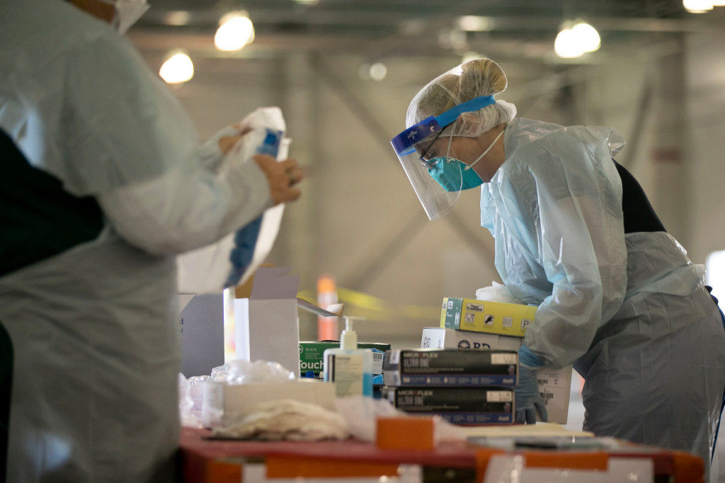 Nurses prepare to enter a COVID-19 testing facility at Cal Expo in Sacramento on April 15. (Photo by Anne Wernikoff for CalMatters)