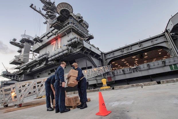 Sailors assigned to the aircraft carrier USS Theodore Roosevelt move meals, ready to eat, for sailors who have tested negative for COVID-19 and are asymptomatic at local hotels in an effort to implement social distancing and stop the spread of COVID-19, April 7, 2020. (U.S. Navy photo/Julio Rivera)