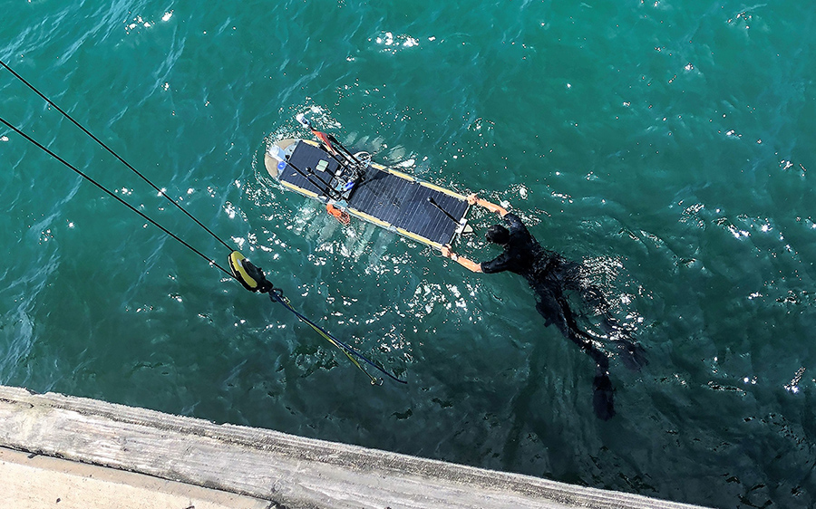 An unmanned surface vessels was deployed from Scripps Pier before embarking on a mission to collect oceanographic and meteorological data 200 nautical miles offshore. 