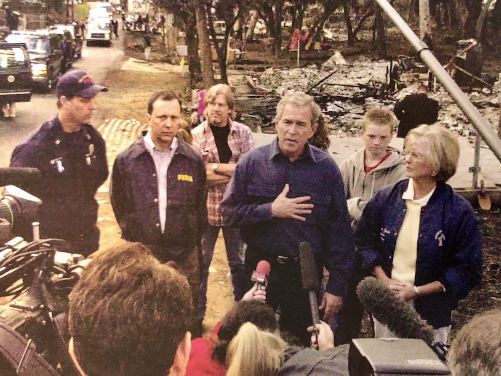 Jacob, far right, with President George W. Bush during a 2003 tour of local wildfire damage.