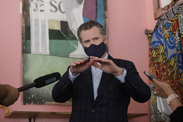 Gov. Gavin Newsom speaks to reporters at Miss Ollie’s restaurant in Oakland on June 9. (Photo by Jeff Chiu, AP Photo/Pool)