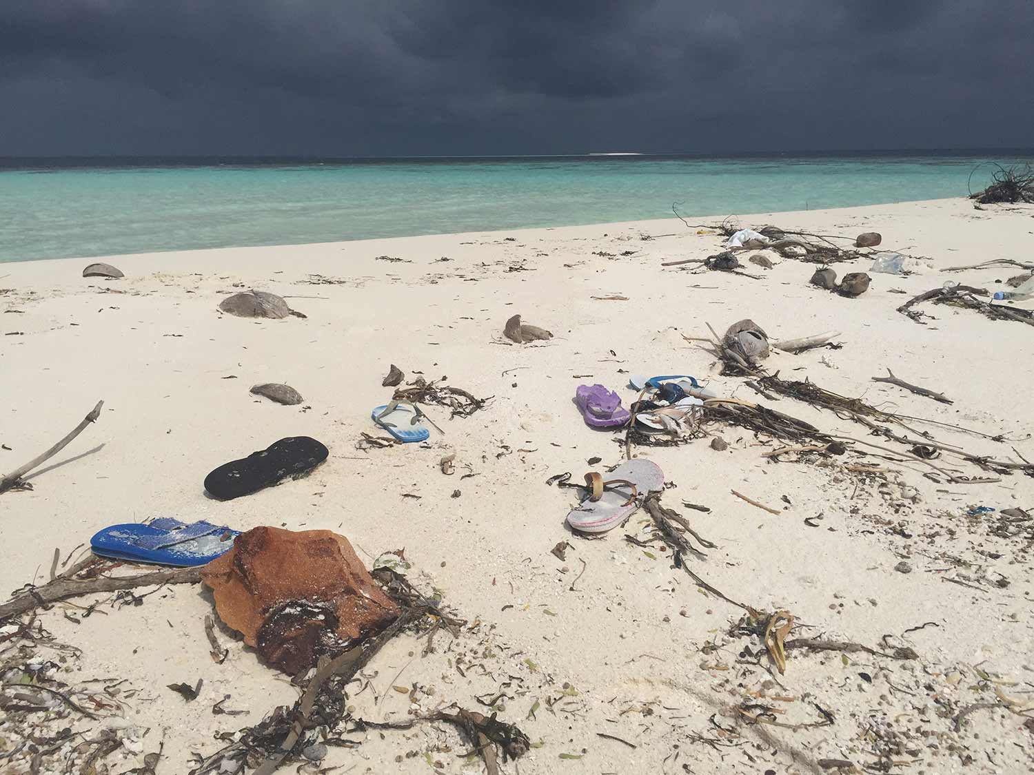 Even a small uninhabited island in the Maldives is marked with human pollution. The flip-flops on this Indian Ocean beach likely came from India or China, more than 1,000 miles away. (Photo courtesy of Stephen Mayfield)