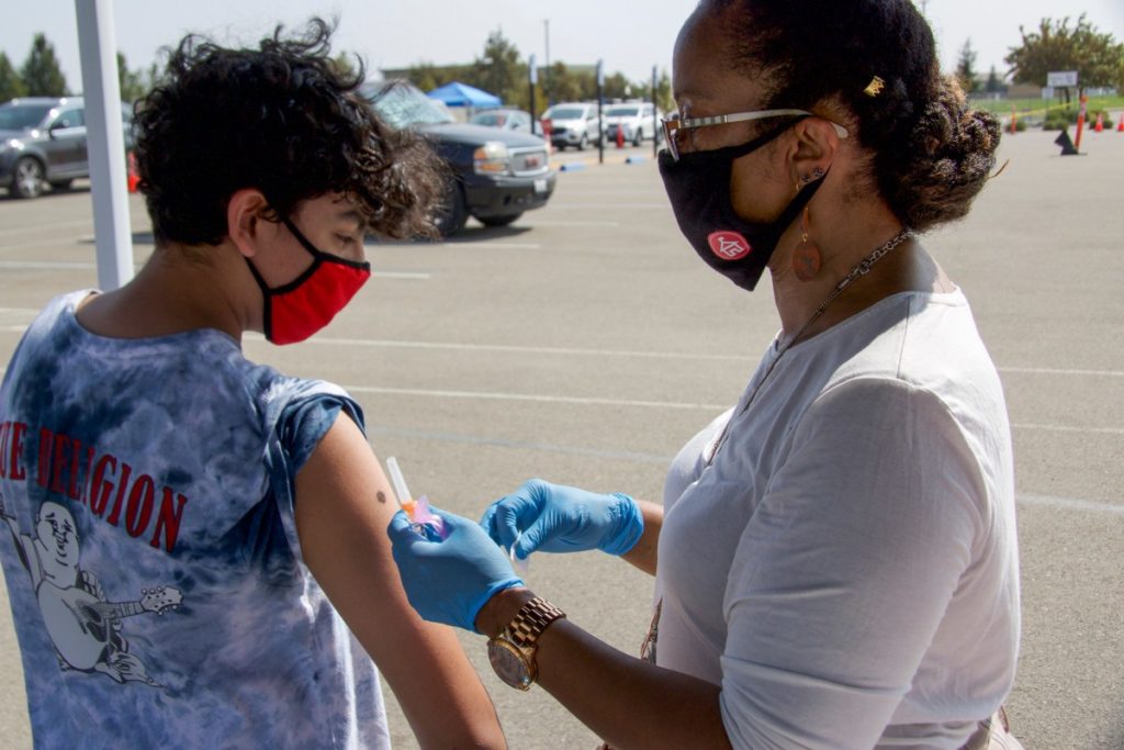 School nurse Dorreen Taylor gives a flu shot to a student at River Islands Technology Academy in Lathrop on Sept. 16, 2020. (Photo courtesy of San Joaquin County Office of Education)
