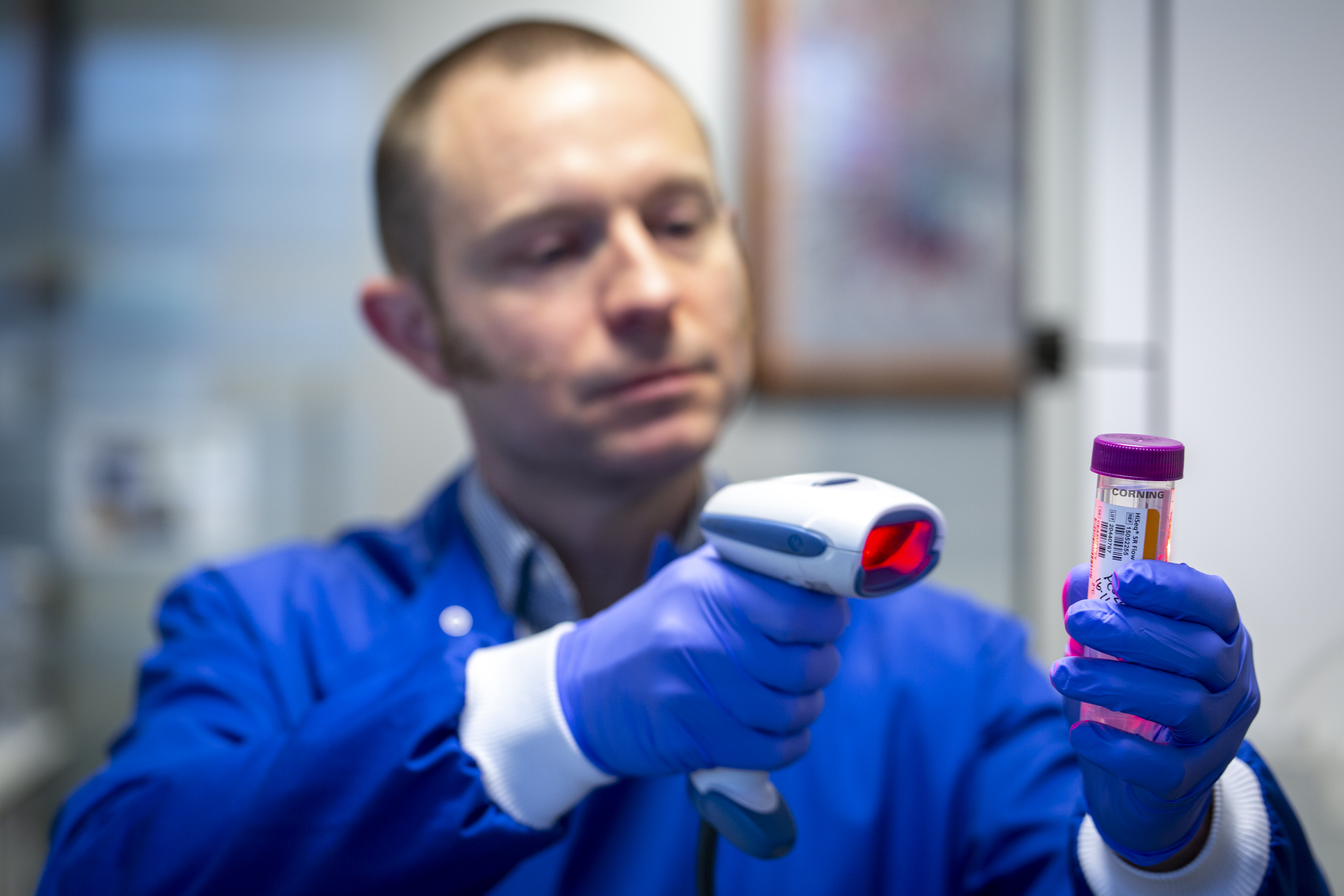 Harper VanSteenhouse, president of BioClavis, scans a saliva collection tube.BioClavis is using the BioSpyder technology for COVID-19 testing in the U.K.