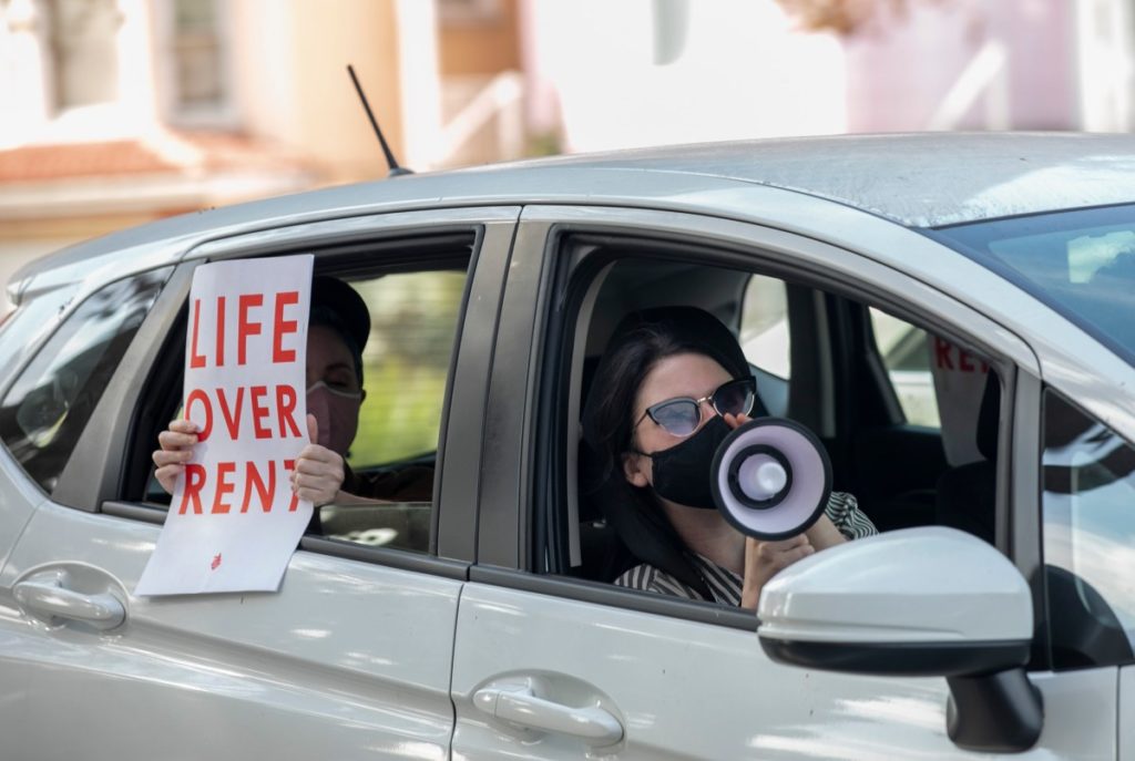 Demonstrators participate in a caravan along Harrison Street in Oakland to protest rent payment and evictions during the coronavirus pandemic on Dec. 5, 2020. (Photo by Anne Wernikoff for CalMatters)