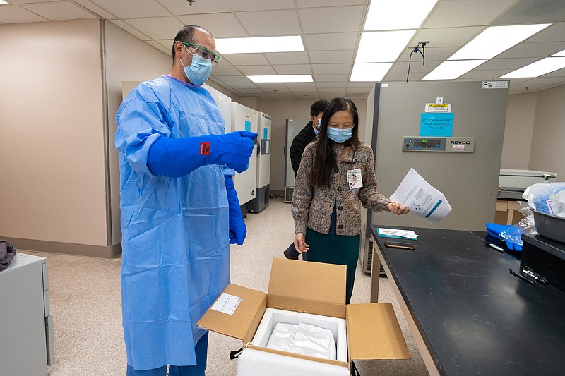 The UC San Diego Health Pharmacy team unpacks the first shipment of Pfizer-BioNtech COVID-19 vaccine, moving the doses into storage in -80 freezers, in an area they call the ‘Freezer Pharm.’ (Credit: San Diego Health)